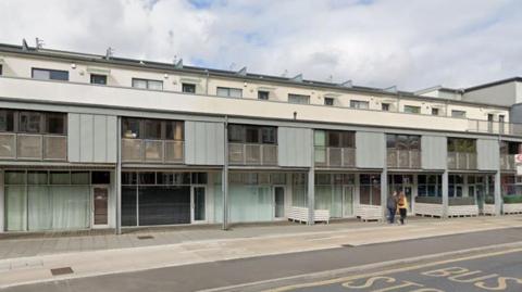 A brutalist maisonette block in white and grey