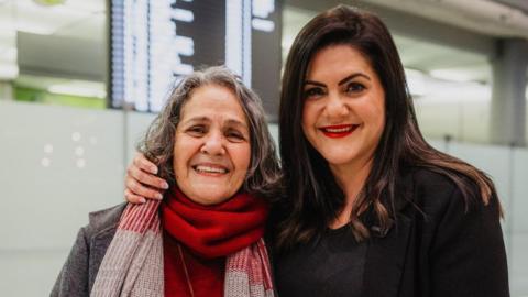 Nahid Taghavi (L) with her daughter Mariam Claren (R) at an airport