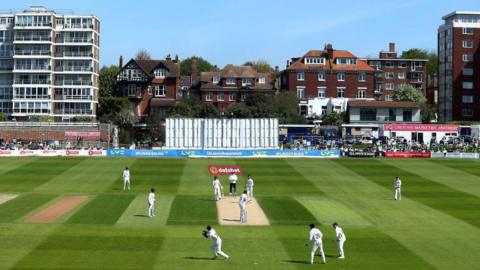 Cricket players on the pitch at Hove