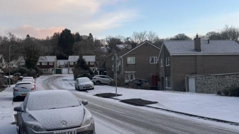 An icy road in Tavistock showing white pavements and road surface.