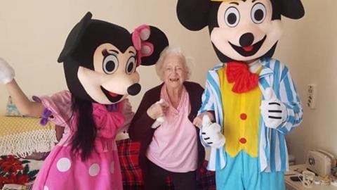 people dressed as Mickey and Minnie Mouse