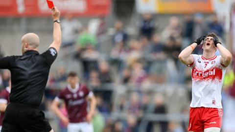 Derry's Gareth McKinless holds his head in his hands after being sent off by Kildare referee Brendan Cawley at Salthill