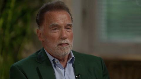 Arnold Schwarzenegger dressed in a shirt and a jacket 