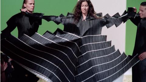 Models display a Pleats Please dress as part of Issey Miyake's Ready-to-Wear Autumn-Winter 1995 fashion show in Paris, France