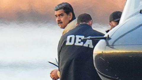 Nicolas Maduro looks over his shoulder