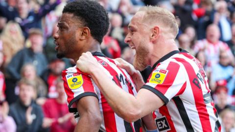 Amad Diallo (left) and Alex Pritchard celebrate the forward's goal for Sunderland against Luton