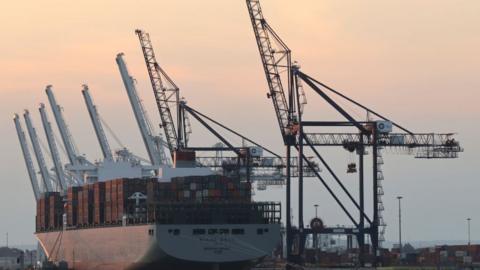 A lot container ship docking at port