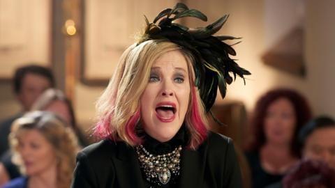 Catherine O'Hara as Moira Rose in Schitt's Creek. She is wearing black with feathers in her hair.