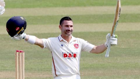 Dean Elgar raises his bat to mark his century