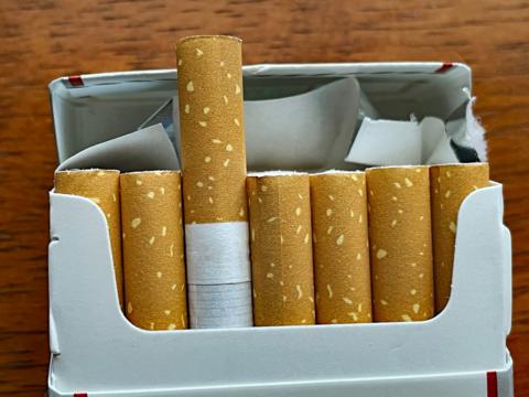 A packet of cigarettes with one cigarette sticking out