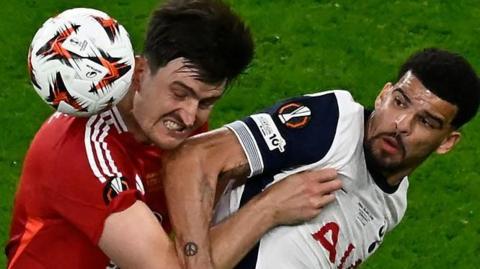 Harry Maguire and Dominic Solanke battle for the ball