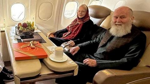 Barbie and Peter Reynolds sitting on a Qatari plane