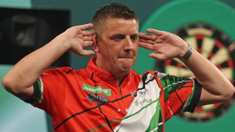 Welsh darts player David Davies salutes the crowd at Alexandra Palace