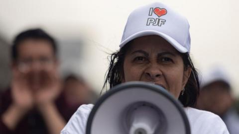 A woman wearing a cap reading "I Love PJF" (acronym for the Federal Judiciary), uses a megaphone as law students and judicial workers protest near the Magdalena Mixhuca Sports Complex where lawmakers hold a session to debate a controversial judicial reform, in Mexico City, Mexico September 3, 2024.