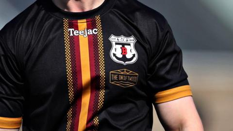 A man wearing a Trearddur Bay football shirt