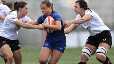 Leinster's Robyn O'Connor attempts to get past Ulster pair Lauren Farrell McCabe with Brenda Barr