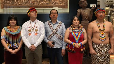 The Shuar delegation in Oxford. They are in traditional, colourful dress.