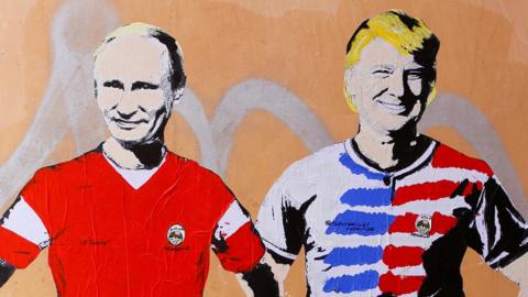 A mural signed by "TV Boy" and depicting Russian President Vladimir Putin and US President Donald Trump as soccer players