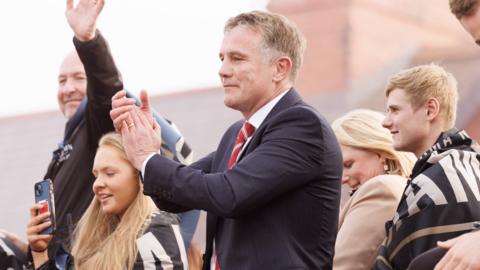 Phil Parkinson celebrates on Wrexham's open-top bus parade