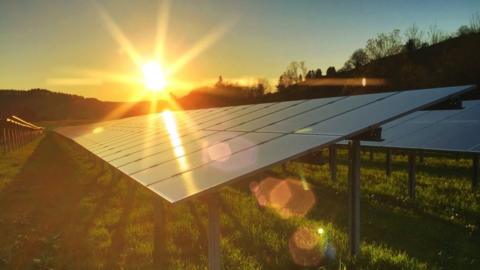 The sun shining on a solar panel