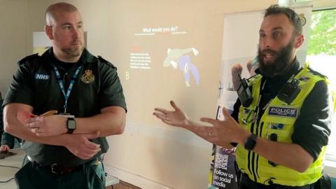 A paramedic and a PCSO delivering the training presentation