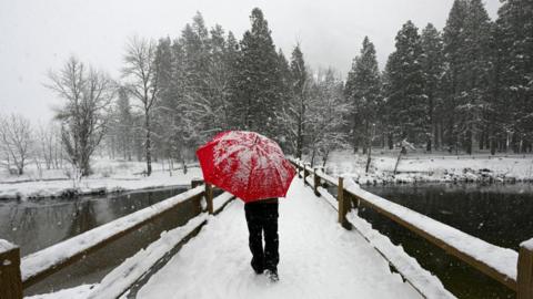 A man walks through Yosemite National Park in February