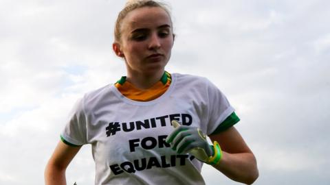 A Donegal player wearing a 'United For Equality' t-shirt