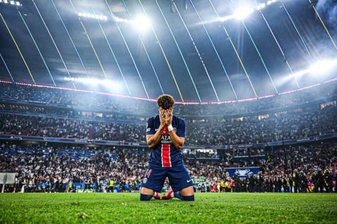 Paris Saint-Germain's Desire Doue appears emotional as he drops to his knees in celebration after his team's victory in the Champions League Final between Paris Saint-Germain and Inter Milan at Munich Football Arena in Munich, Germany. Photo by Michael Regan