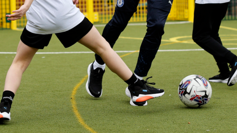 Children in the free kits play football