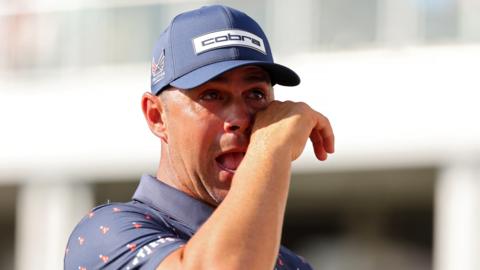 American golfer Gary Woodland wipes away a tear after winning the Houston Open