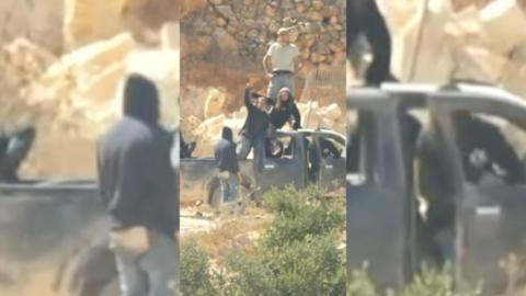 Israeli settlers stood on top of a pickup truck