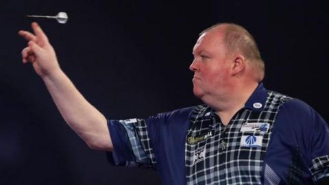 John Henderson throws a dart