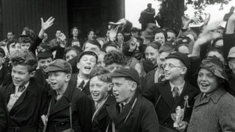 Crowd of children cheering