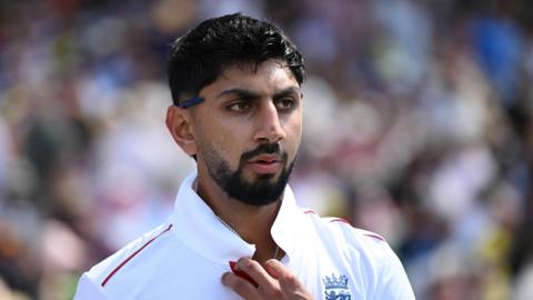 Shoaib Bashir looks on