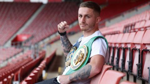 Ryan Garner poses for photo at St Mary's Stadium with his European and WBC International belts on his shoulders