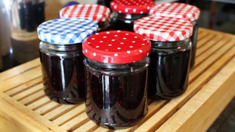 Several jars of homemade jam on a wooden table