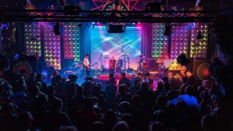 Colourful lighting on stage during a performance at Club 85