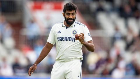 Jasprit Bumrah looks at the ball