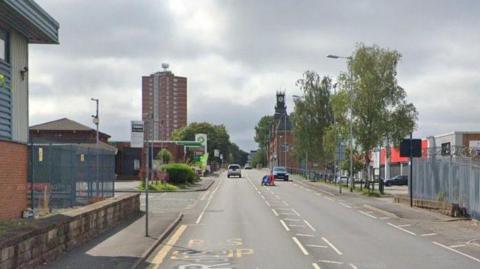 A number of buildings can be seen on a section of Featherstall Road South, including a tower block and a petrol station