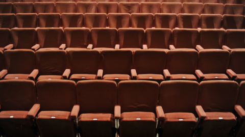 A shot of red empty seats at a a theatre 