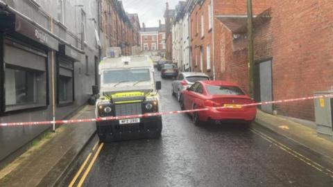 Police vehicles pictured at the scene following the fire in Harvey Street