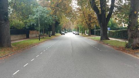 Pittville Circus Road in Cheltenham on an autumn day, lined with trees