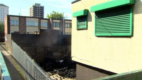 The fire started at the back of a derelict shop, but the intense heat damaged the windows of nearby homes