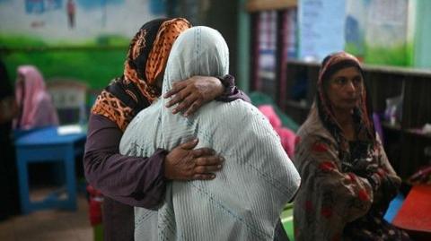 Families at a school where unidentified bodies have been kept