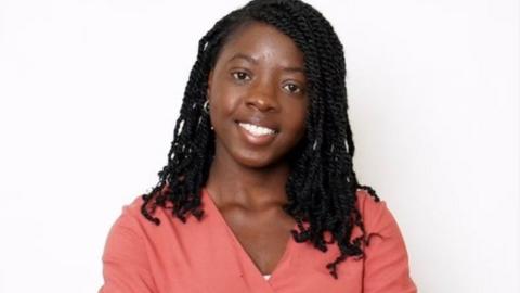 A portrait image of Rach Idowu wearing a pink shirt