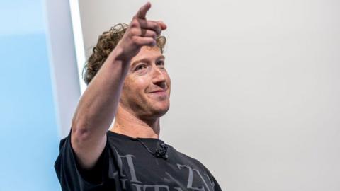 Meta boss Mark Zuckerberg smiles and points a finger