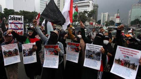 Hundred of protesters hold a protest near the State Palace in Jakarta, Indonesia on March 20, 2023. The protesters demanded the Indonesian government reject Israeli soccer team participation in the upcoming FIFA U-20 World Cup.