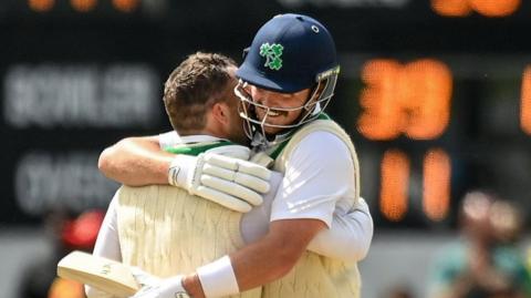 Andy McBrine and Mark Adair embrace after securing victory for Ireland 