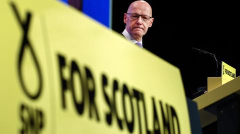 SNP leader John Swinney on stage during the SNP's party conference in Edinburgh in September