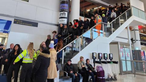 Queues of people during an evacuation at Gatwick Airport. 